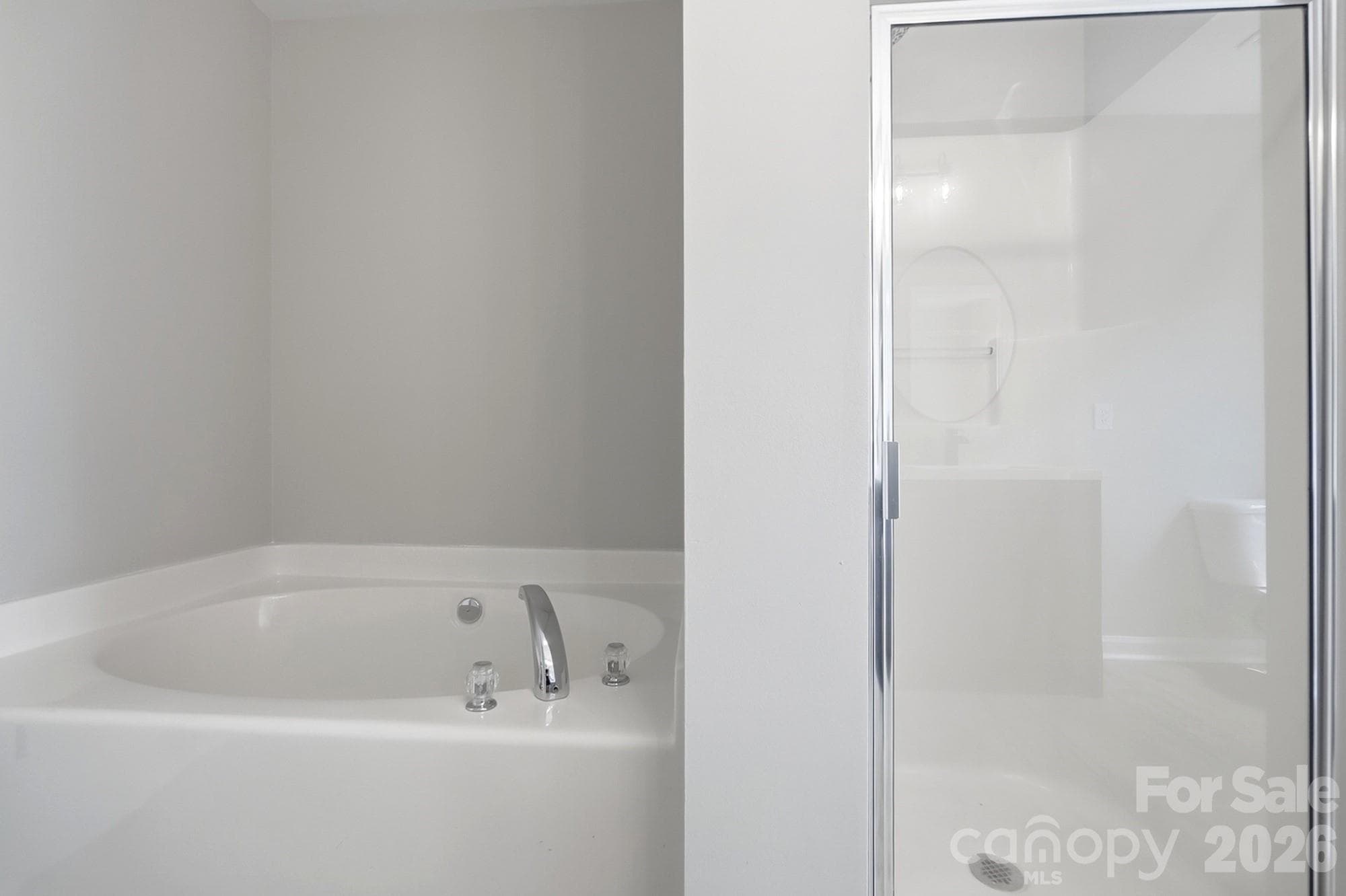 Primary Bathroom with soaker tub and walk-in shower - 11402 Heritage Green Drive, Cornelius