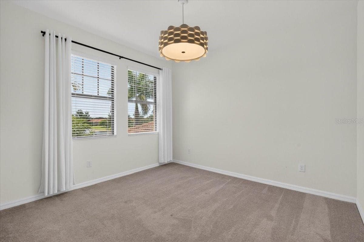 Second Bedroom with designer light fixture and window treatments - 10059 CROOKED CREEK DR #202, VENICE