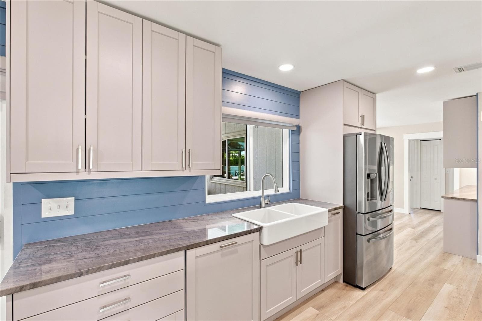 Kitchen (dishwasher with cabinetry cover, farm sink, stainless steel refrigerator) - 302 DEGAS DR, NOKOMIS