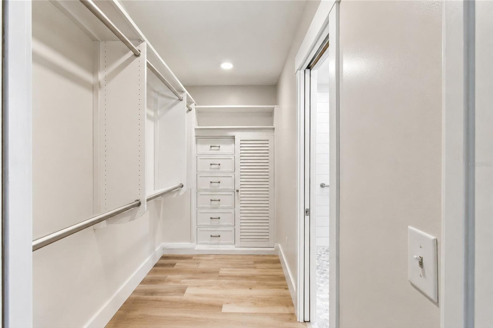 Primary bedroom walk-in closet (photo enhanced to remove items in closet) - 302 DEGAS DR, NOKOMIS