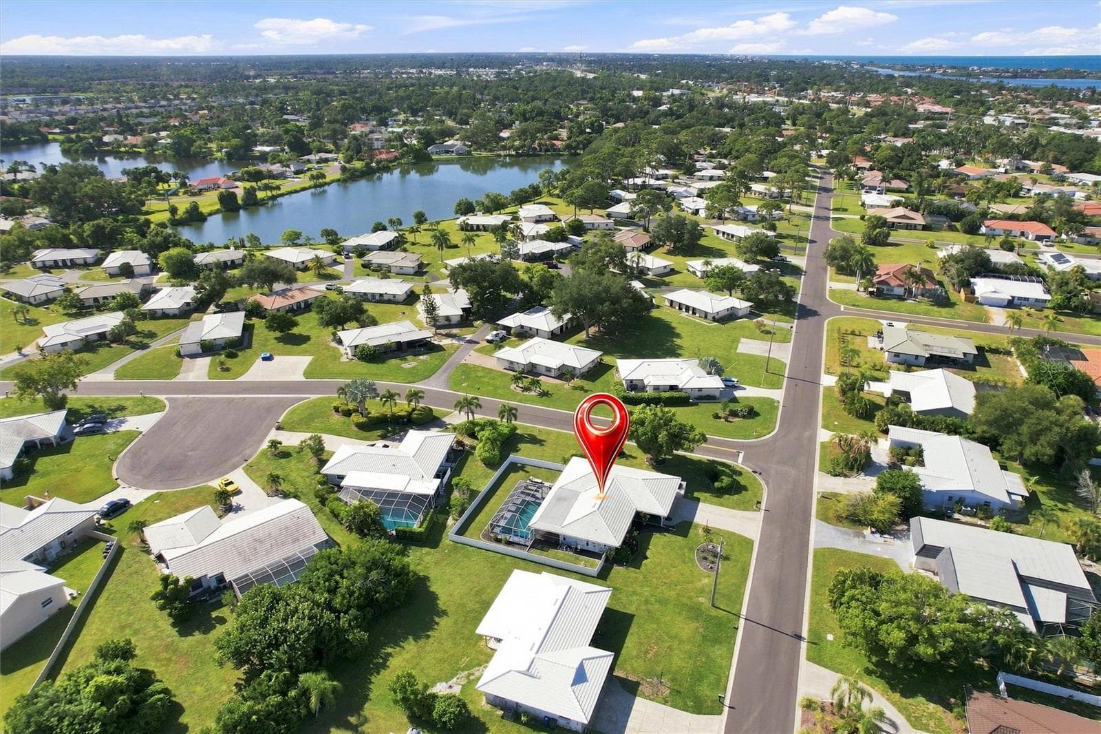 Aerial of home and neighborhood homes and lakes - 302 DEGAS DR, NOKOMIS