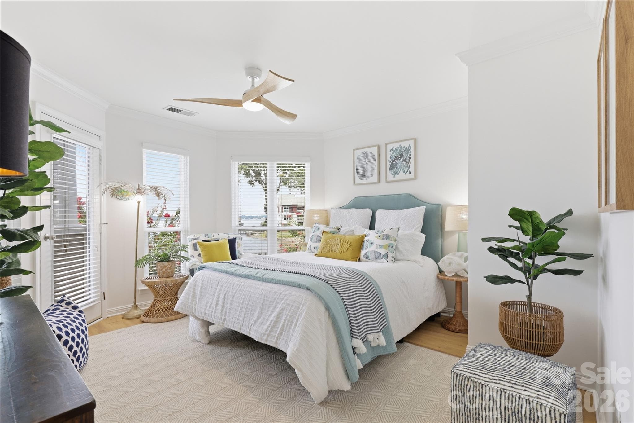 Primary bedroom provides a comfortable private retreat with water views and porch access - 932 Southwest Drive, Davidson