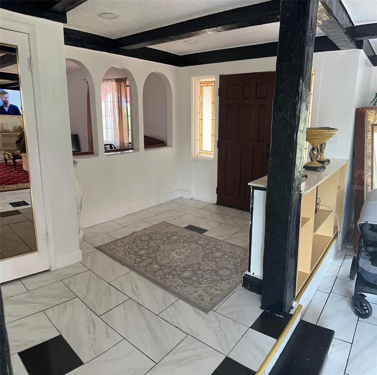 FOYER. ARCHED OPENING SHOWING TV/2ND LIVING ROOM/OFFICE - 1238 FLOTILLA DR, HOLIDAY