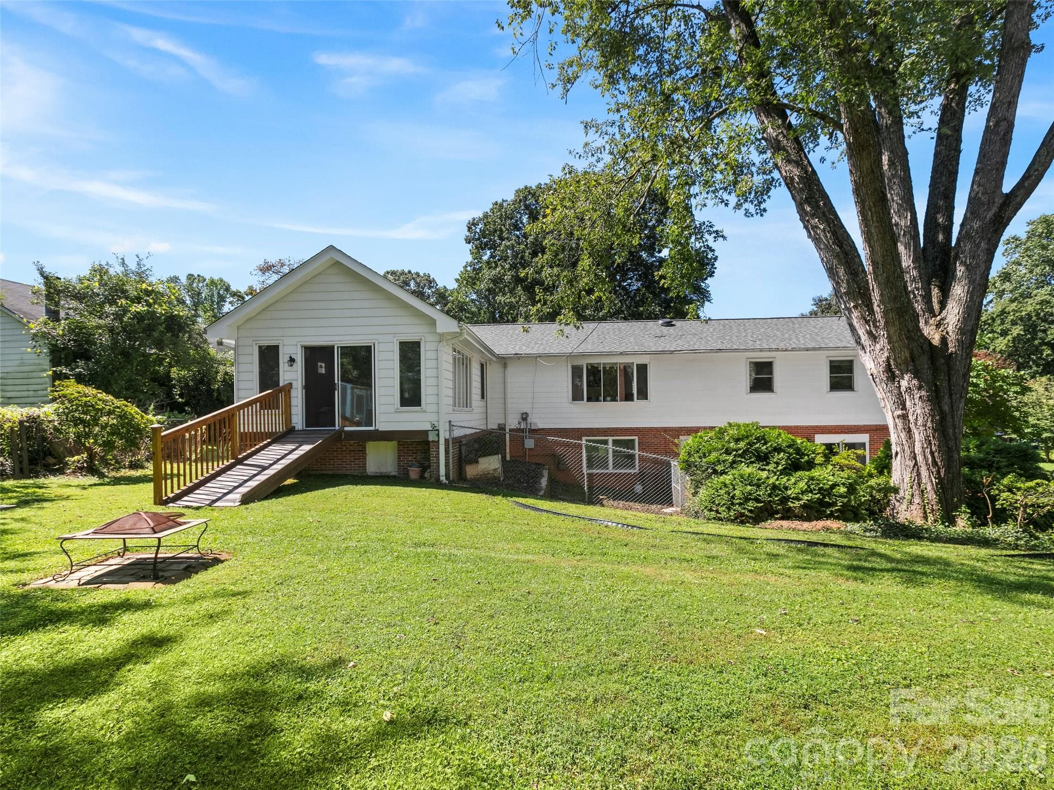 Back view of the home, with a lovely, grassy, gently-sloping yard! - 101 Castlerock Drive, Asheville