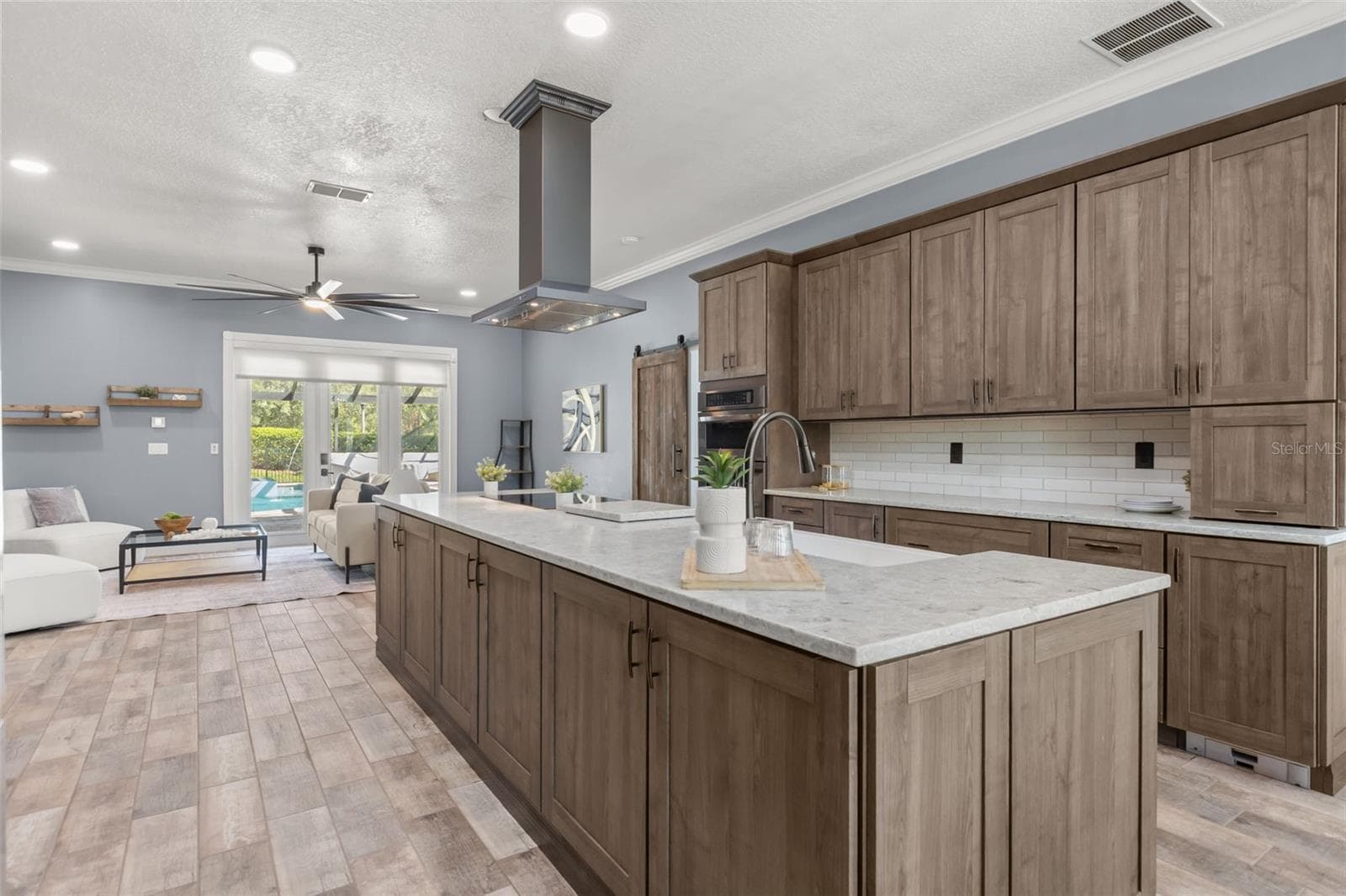 The 3'x12' island was added with a deep one-piece apron sink, induction cooktop, and custom vent hood ~ - 5006 RISHLEY RUN WAY, MOUNT DORA