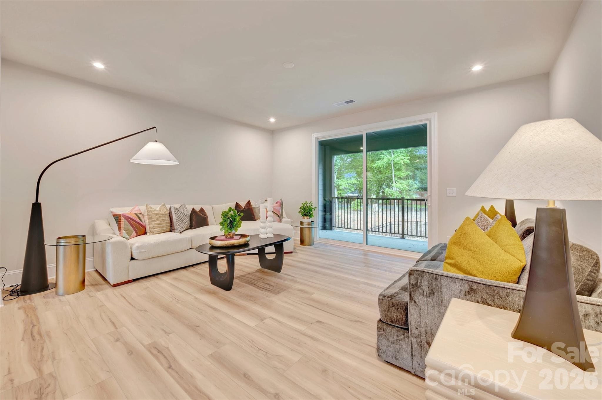 Living room with access to the covered outdoor living space - 309 Old Town Village Road, Waxhaw