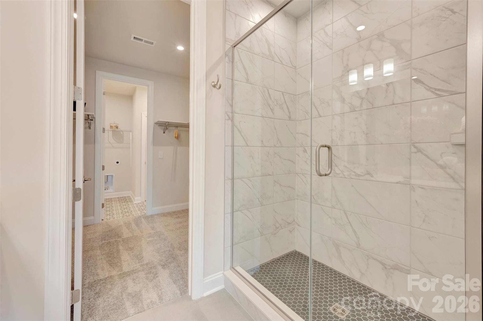Primary walk-in closet with connection to the laundry room - 309 Old Town Village Road, Waxhaw