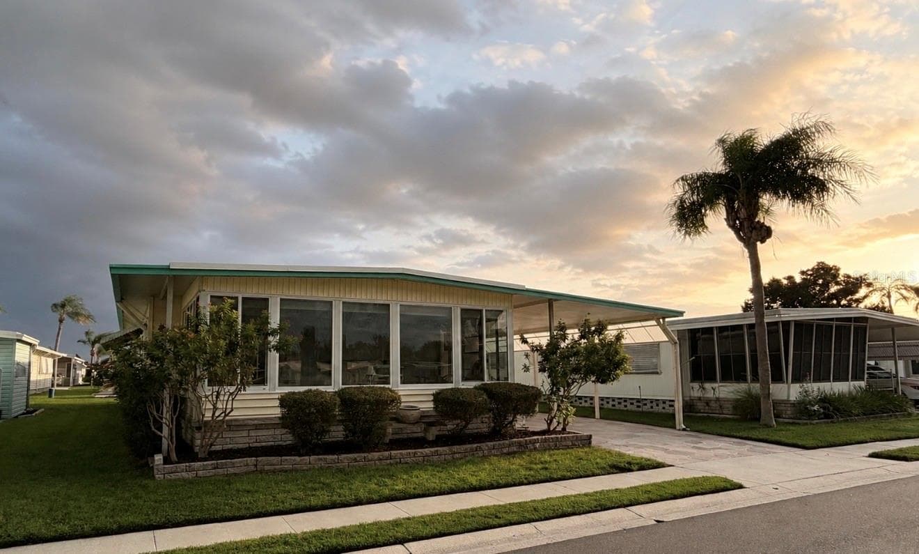 Front of home with sunset - 1100 BELCHER RD S #304, LARGO