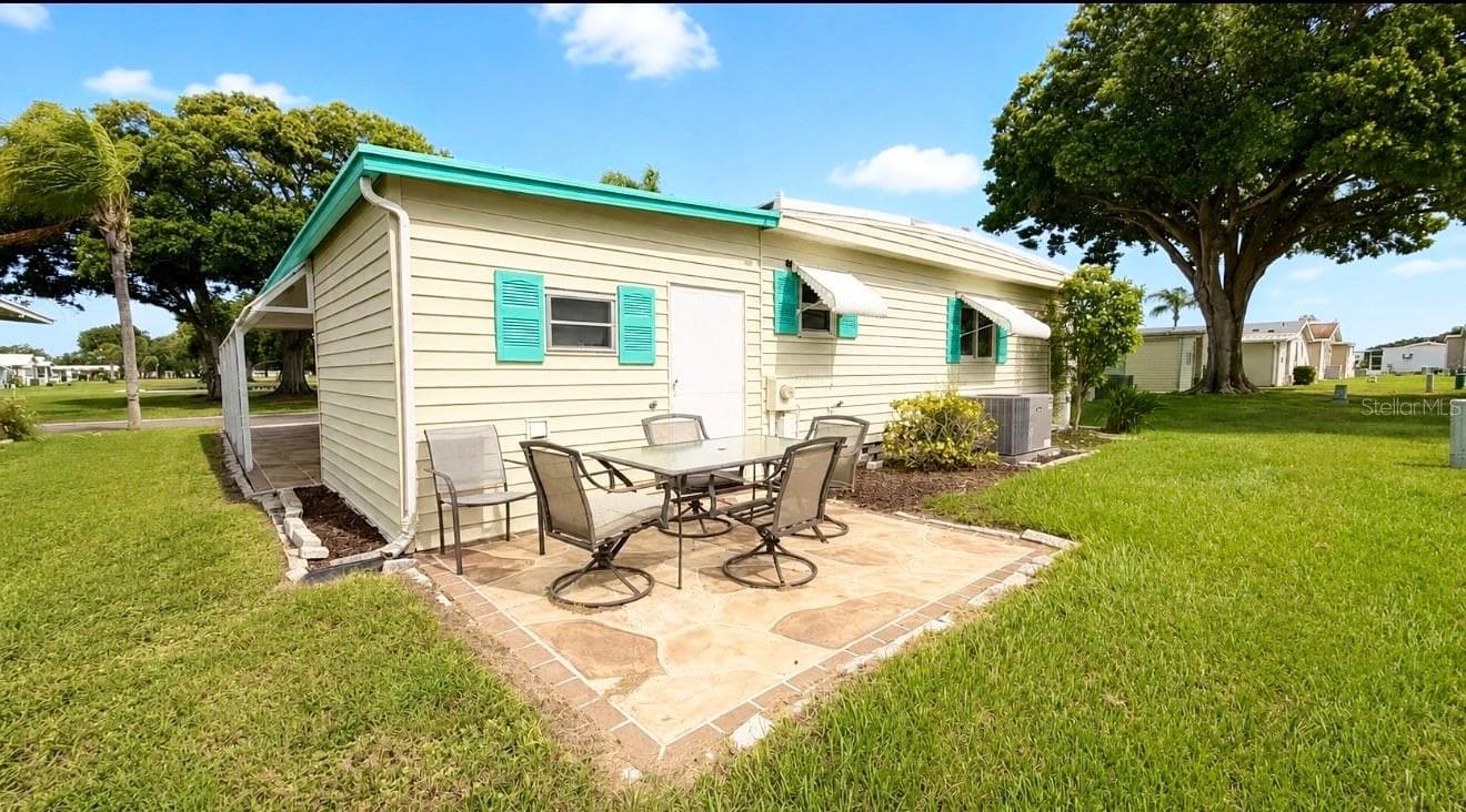Back of home with open patio - 1100 BELCHER RD S #304, LARGO