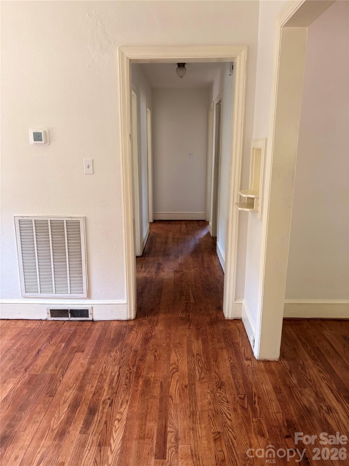 Hallway to sleeping quarters with newly refinished wood flooring - 725 5th Avenue SW, Hickory