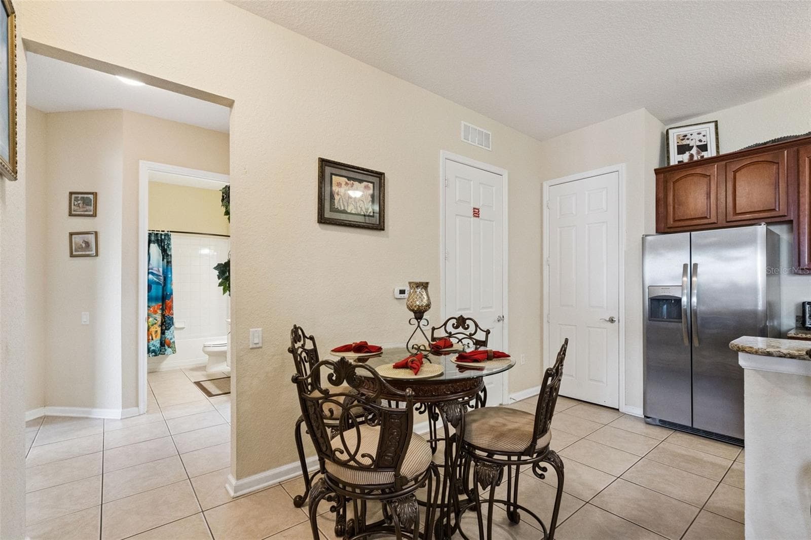 Dining Nook:Casual dining space situated adjacent to the kitchen, featuring neutral tile flooring and easy access to pantry storage. - 4840 CAYVIEW AVE #405, ORLANDO