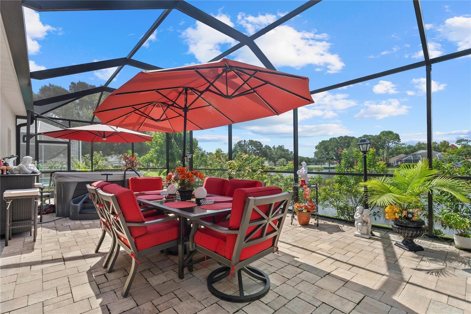 Dine outside in the new screen enclosure with new pavers, while enjoying the lake views. - 11326 BLUE SAGE PL, LAKEWOOD RANCH