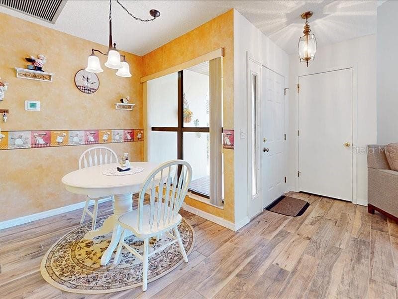 Front door and coat closet. Eating space in the kitchen area - 118 COVENTRY LN, HAINES CITY