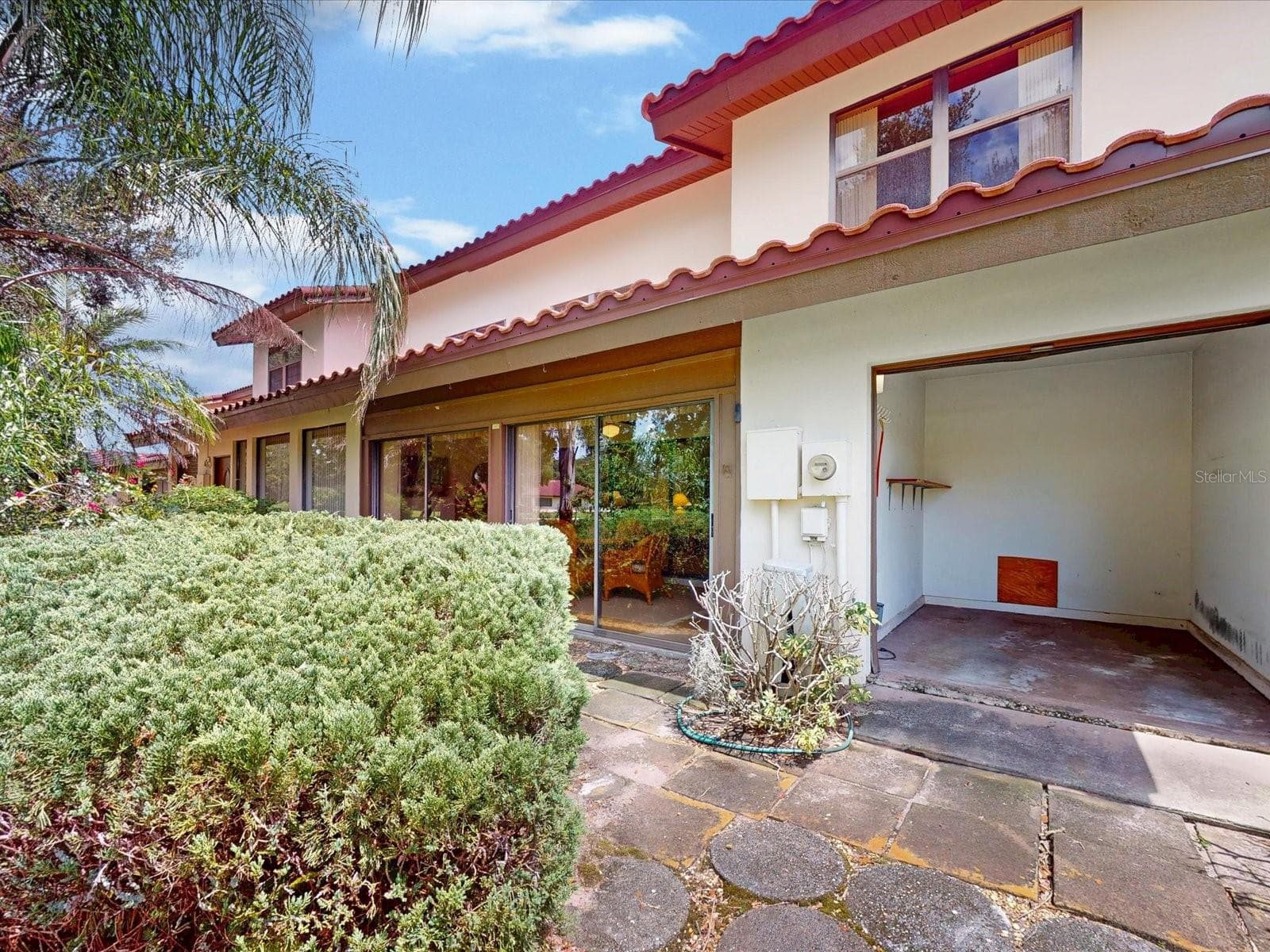 Just outside the lanai is your own golf cart garage - 105 COVENTRY LN, HAINES CITY