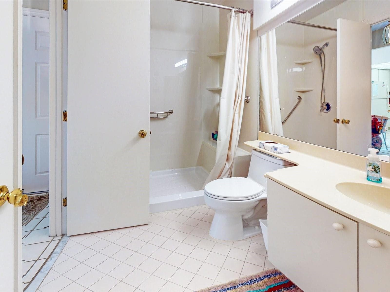 Just past the closets is the guest full bath - 105 COVENTRY LN, HAINES CITY