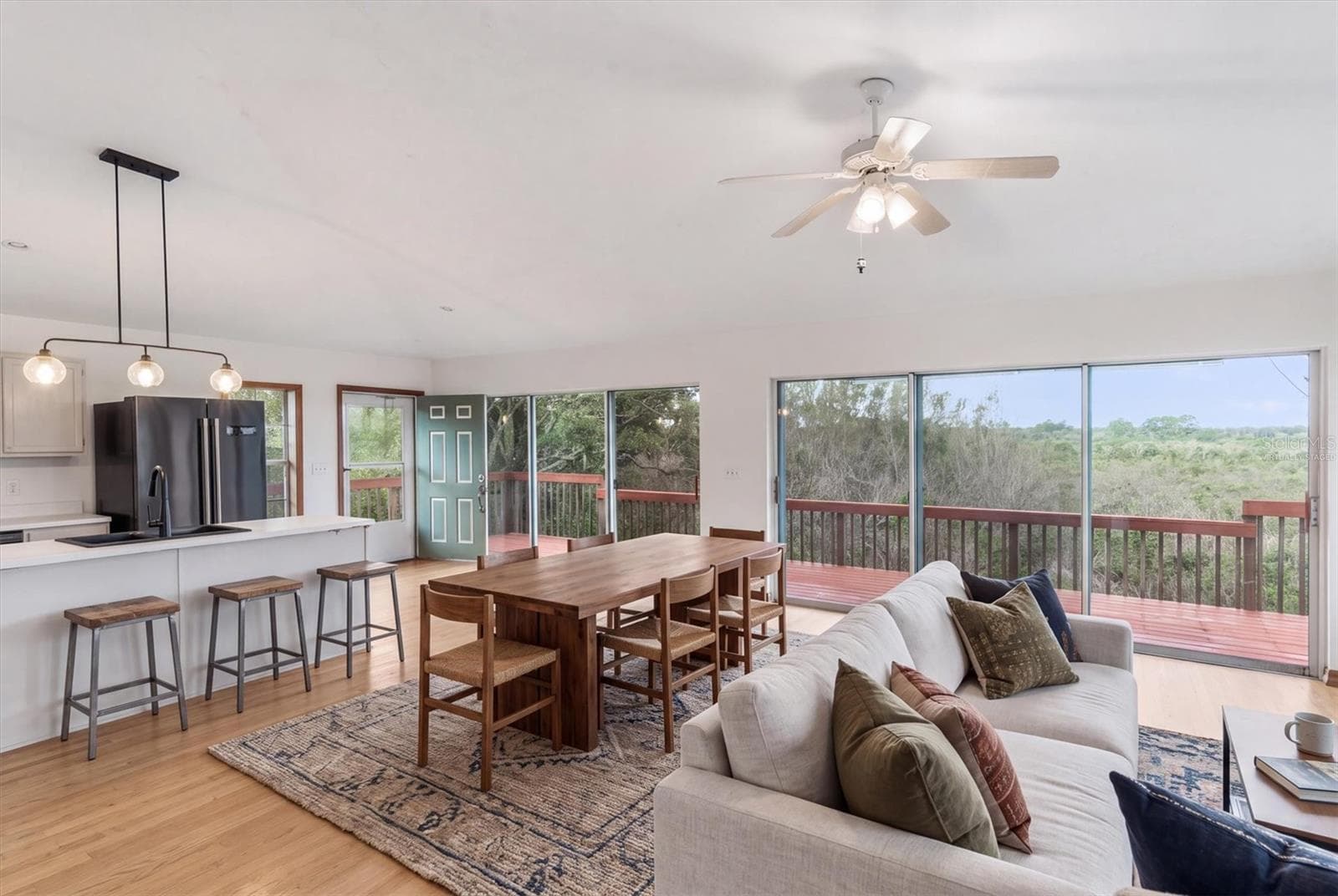 Virtually staged living room and dining area - 1835 OAK PL, FLAGLER BEACH