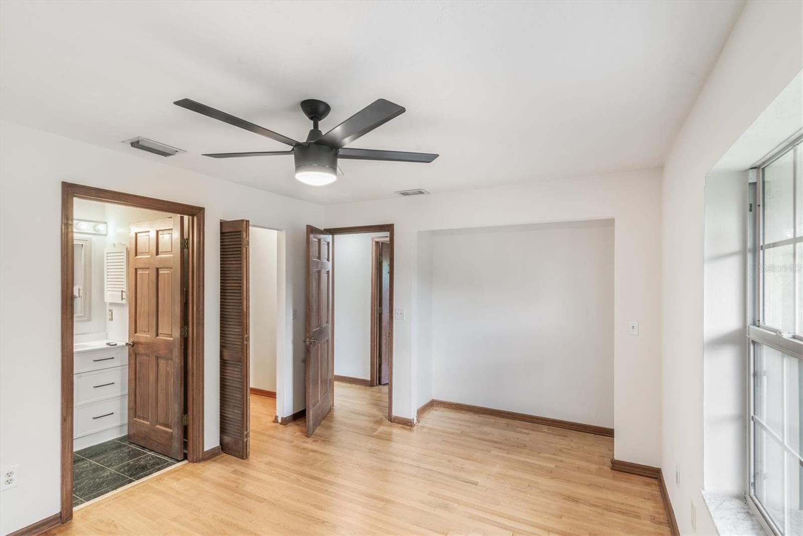 Master Bedroom with master bath and walk-in closet to left - 1835 OAK PL, FLAGLER BEACH