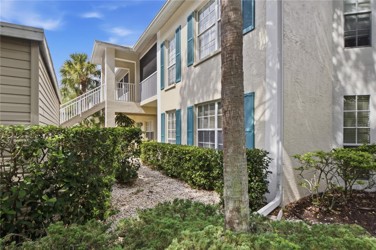 Front of condo between carport and condo - 418 LAUREL LAKE DR #106, VENICE