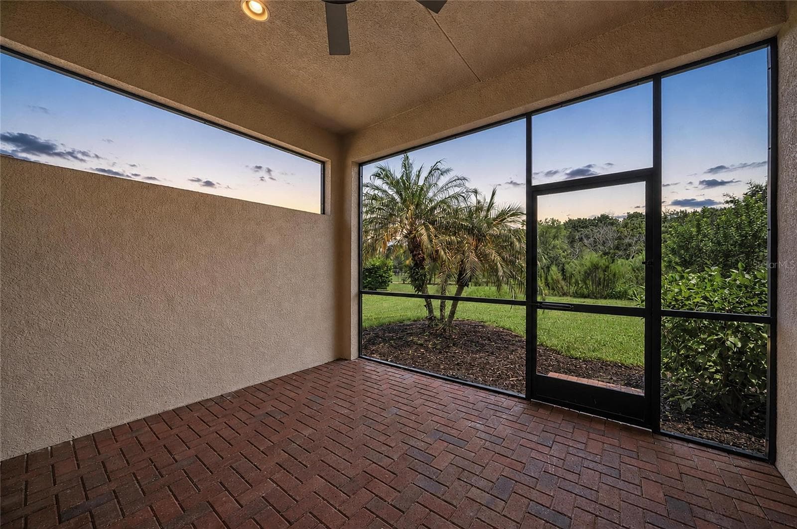 Back Lanai at dusk - 4645 ROYAL DORNOCH CIR, BRADENTON