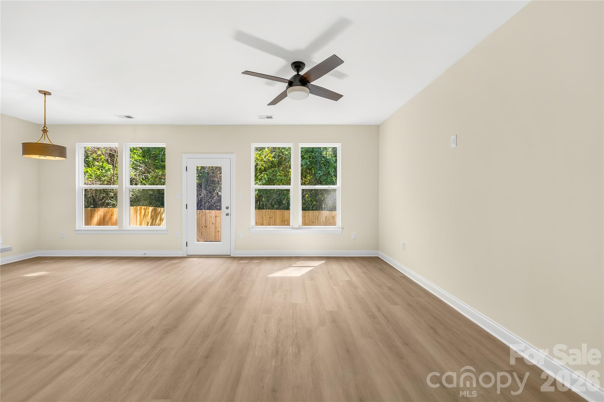 Open living and dining area with natural light and LVP floors in a 2026 new construction home in east Charlotte - 1940 Purser Drive, Charlotte