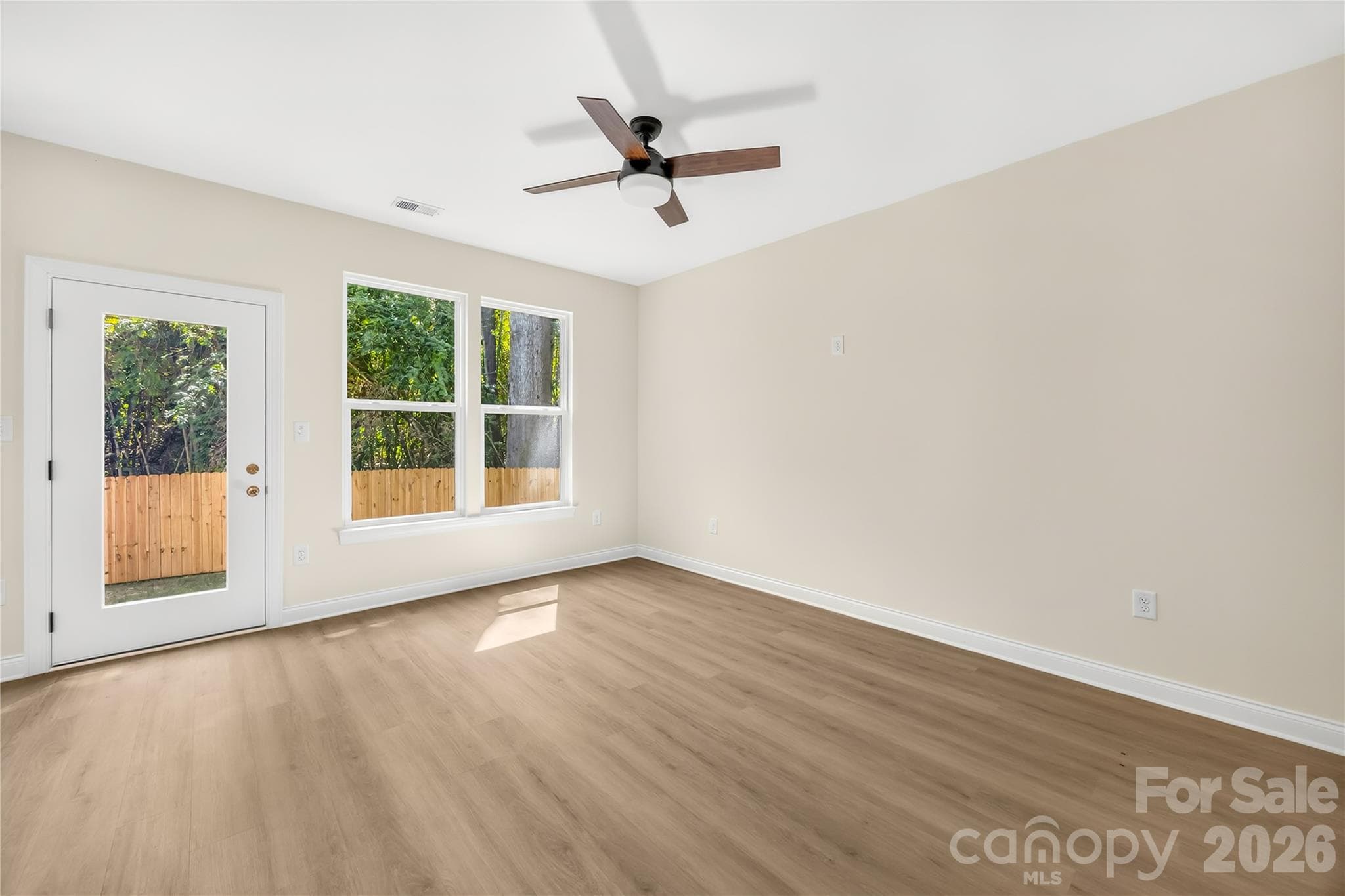 Living room on the open main level of this new construction duet in Charlotte's Eastwood Acres neighborhood - 1940 Purser Drive, Charlotte