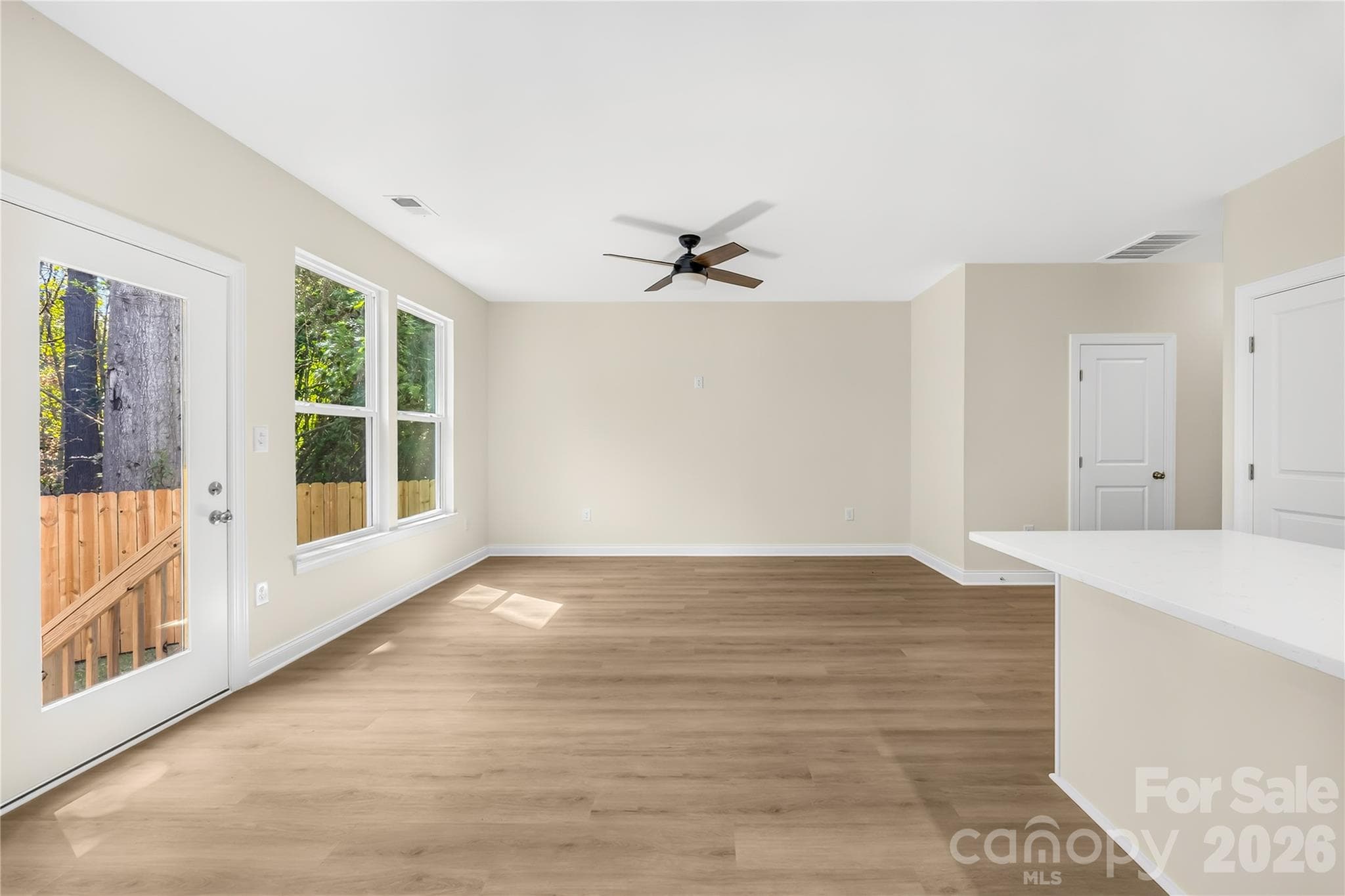 Main-level living area with LVP floors and modern lighting at 1940 Purser Dr, Charlotte, NC - 1940 Purser Drive, Charlotte