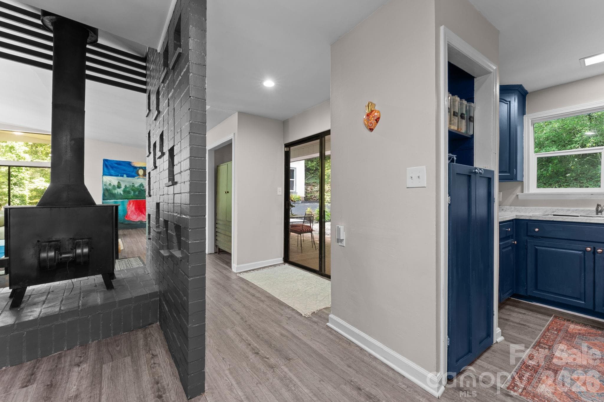 Great Room, Wood Stove, Slider to Back Patio Slider & Kitchen to the right - 103 Riverwood Drive, Sylva