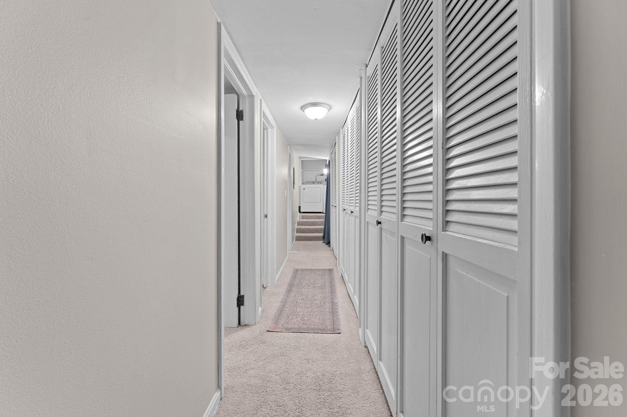 Hallway, 2 bedrooms on Left, Closets on Right and Laundry at the End - 103 Riverwood Drive, Sylva