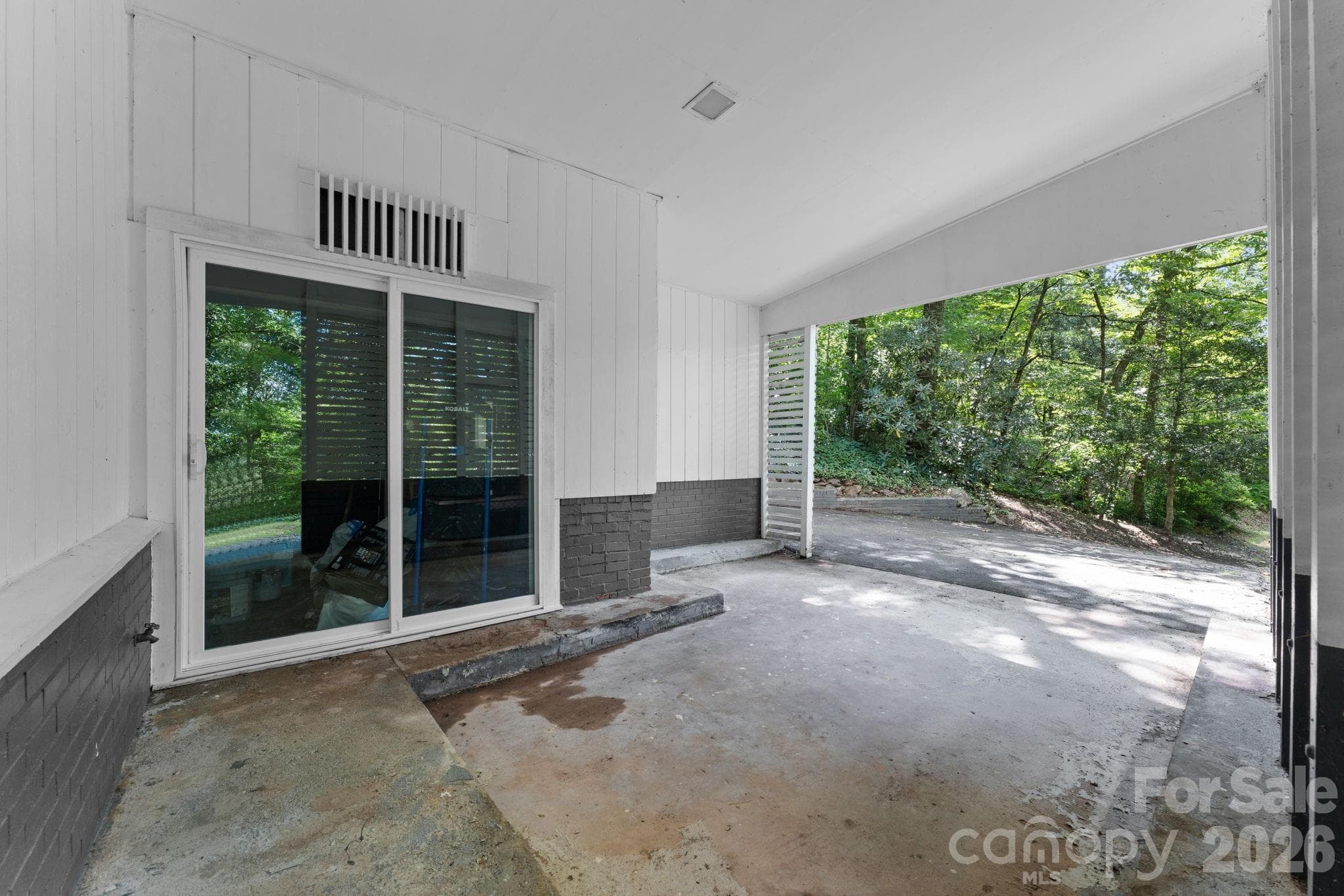 Inside of Carport & Slider to Storage Room - 103 Riverwood Drive, Sylva
