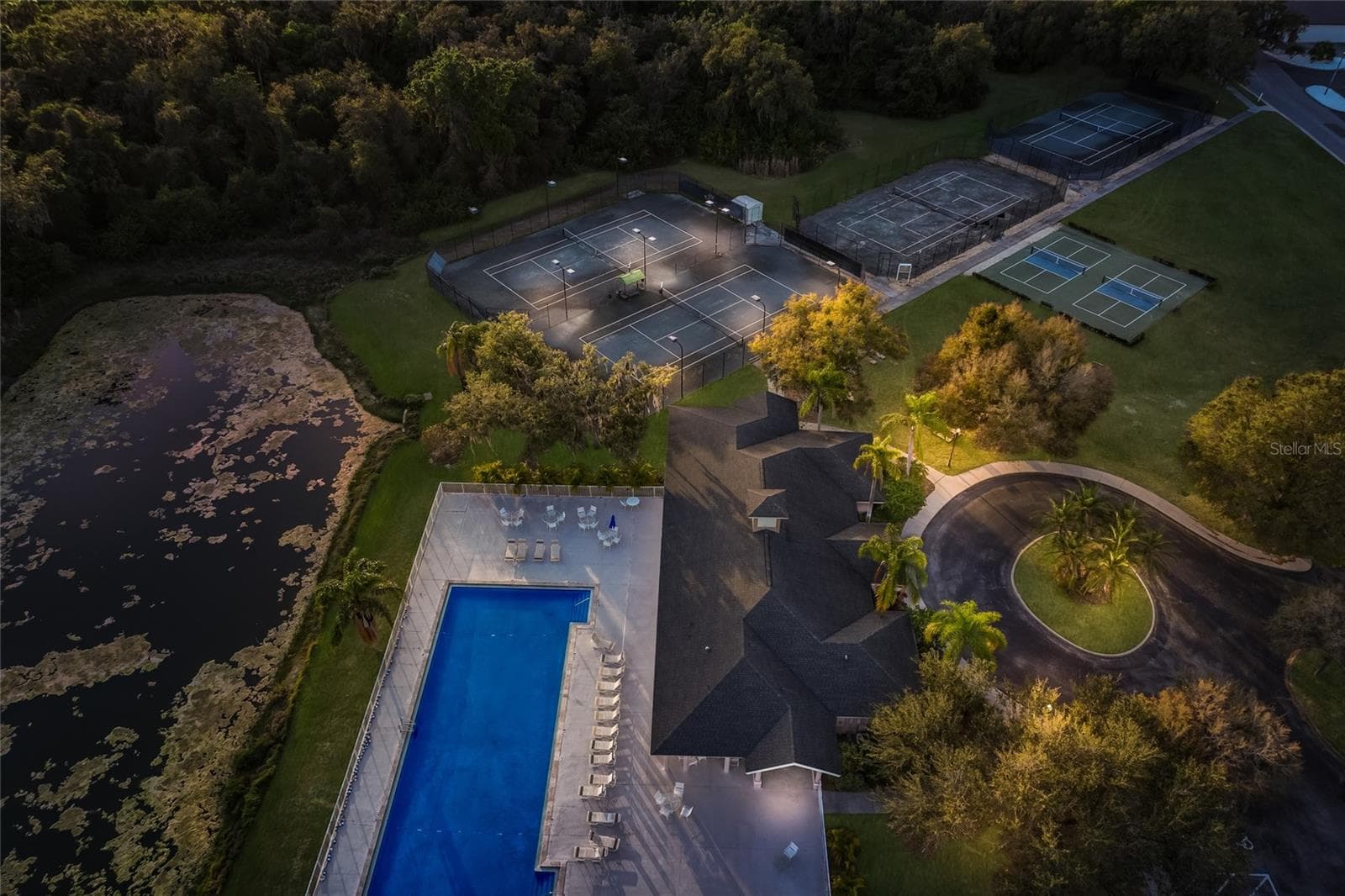 Aerial view of the pool and tennis facilities at The Club at RW. - 3649 WILDERNESS BLVD W, PARRISH