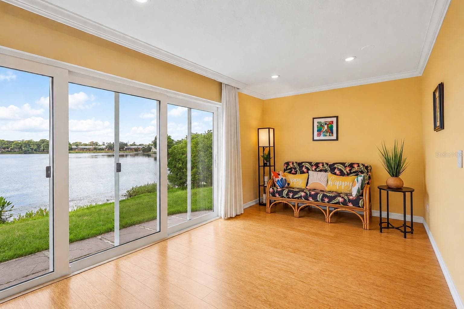 The Dining area enjoys peaceful backyard and LAKE VIEWS and features sliding glass doors that invite NATURAL LIGHT inside while enhancing the home's indoor-outdoor feel. - 632 DESOTO DR #632, CASSELBERRY