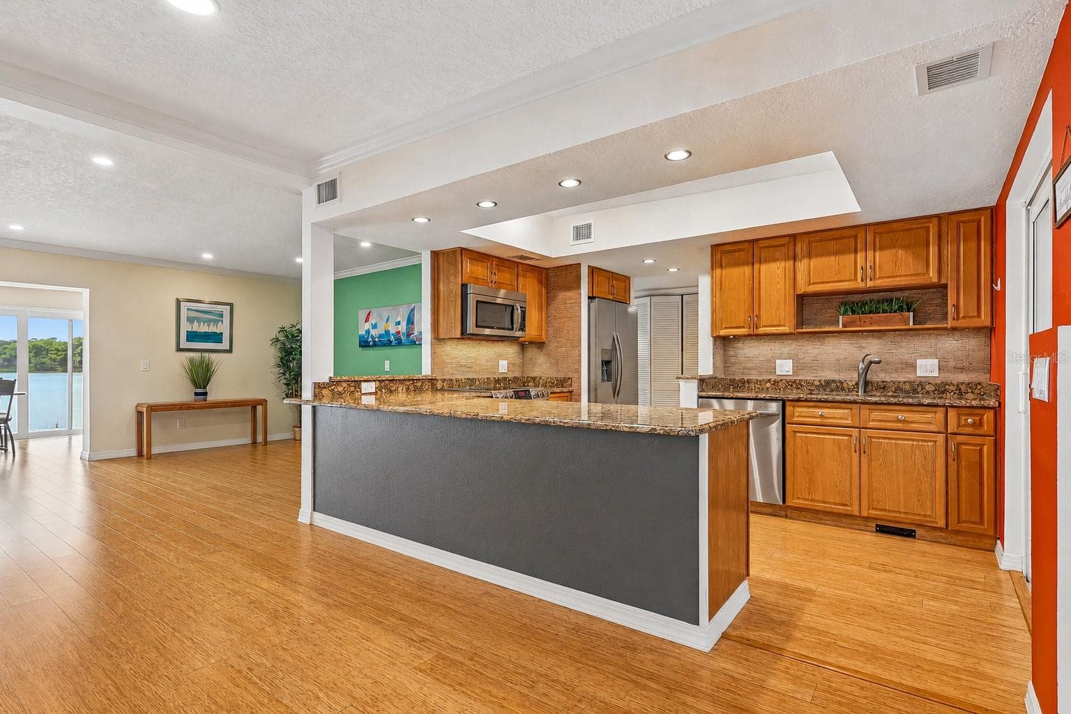 The breakfast bar has room for counter-height stools and provides extra prep space. - 632 DESOTO DR #632, CASSELBERRY