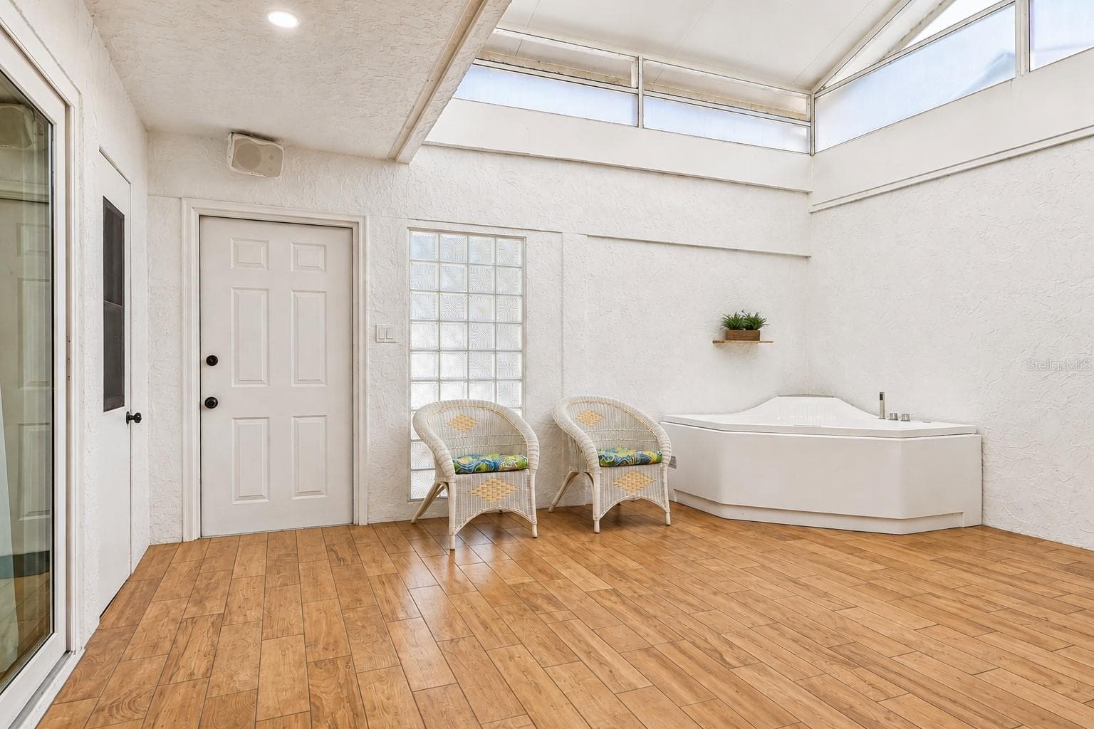 One of the home's most unique features is the spectacular BONUS ROOM/CONSERVATORY, a light-filled retreat complete with a SPA AND TANKLESS WATER HEATER (2021). - 632 DESOTO DR #632, CASSELBERRY