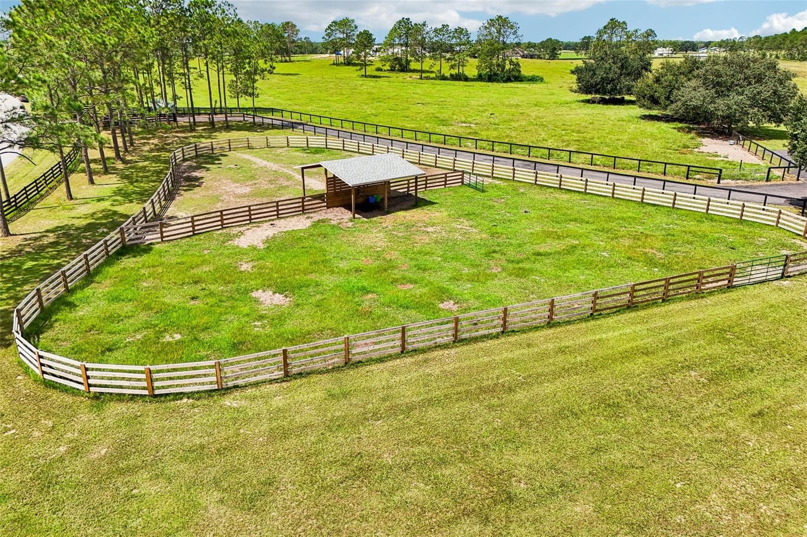 A shared 20' x 24' run-in barn between Paddocks 1 & 2 provides a spacious, shaded shelter for the horses. - 2088 NW 102ND BLVD, WILDWOOD