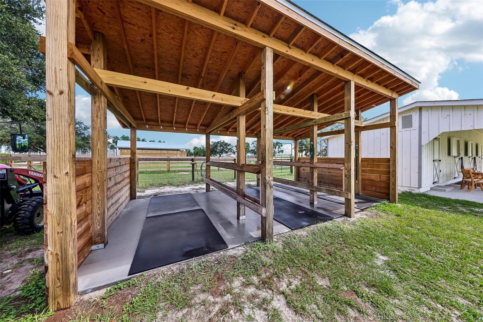 Heavy-duty overhead beams provide secure tie points for safely handling horses, including dental visits and routine care. - 2088 NW 102ND BLVD, WILDWOOD