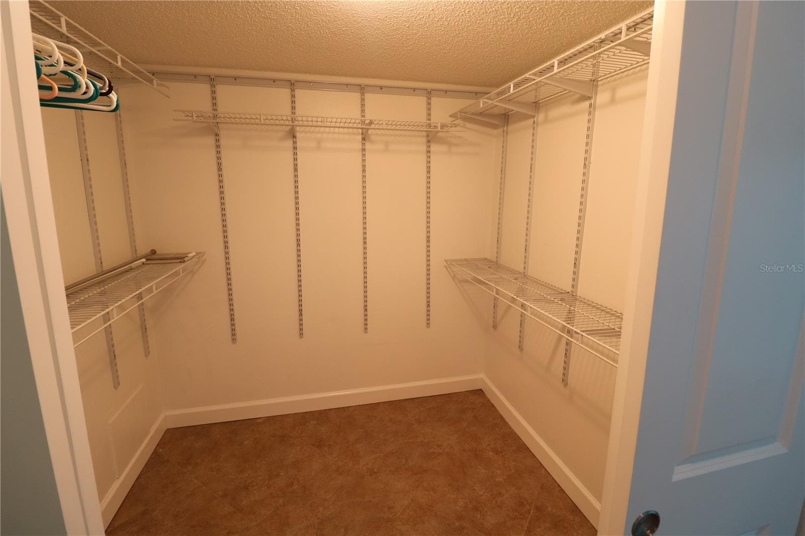 Primary bedroom walk in closet - 9495 BLIND PASS RD #504, ST PETE BEACH