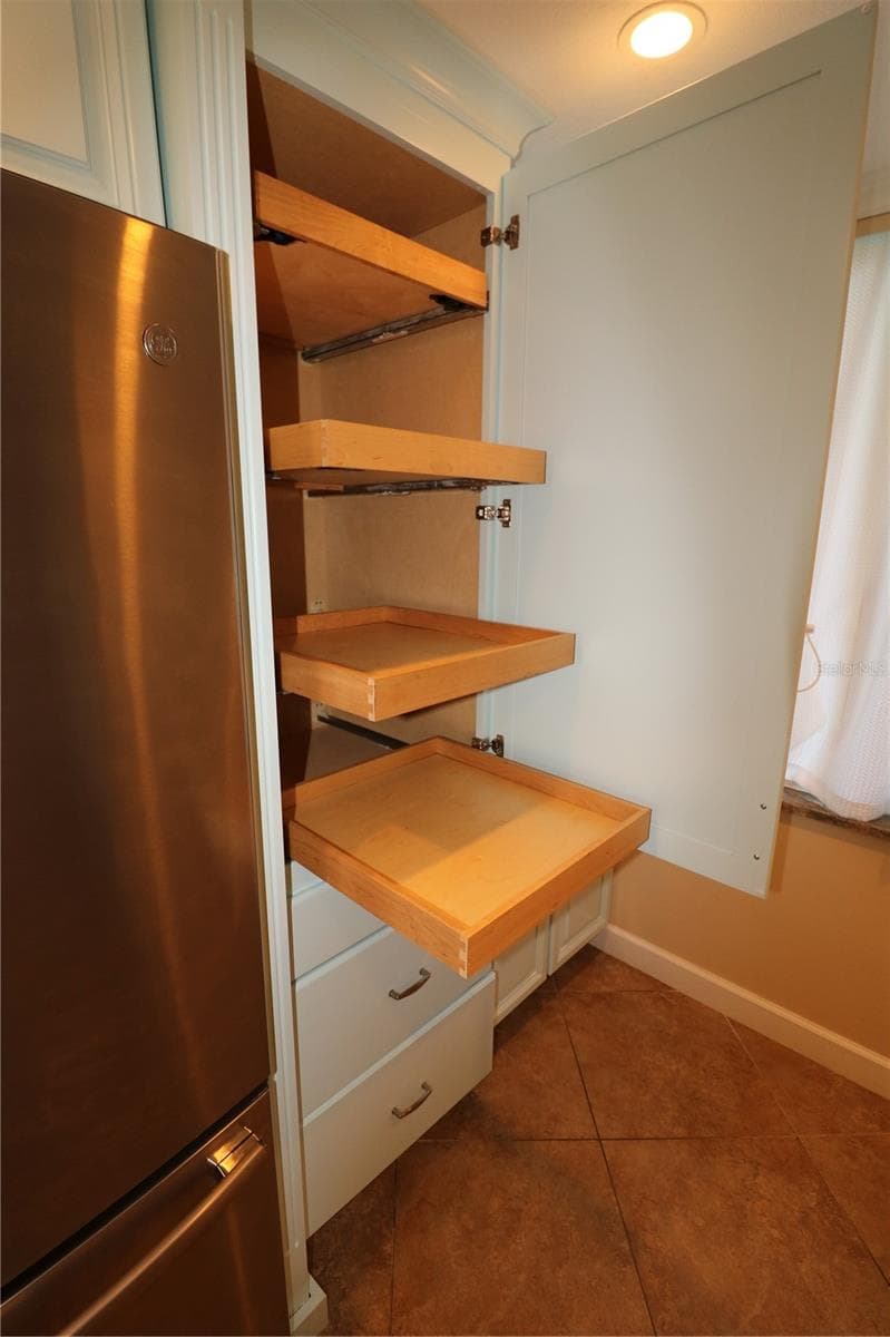 Pantry cabinet has pull out shelves for convenience and easy access - 9495 BLIND PASS RD #504, ST PETE BEACH