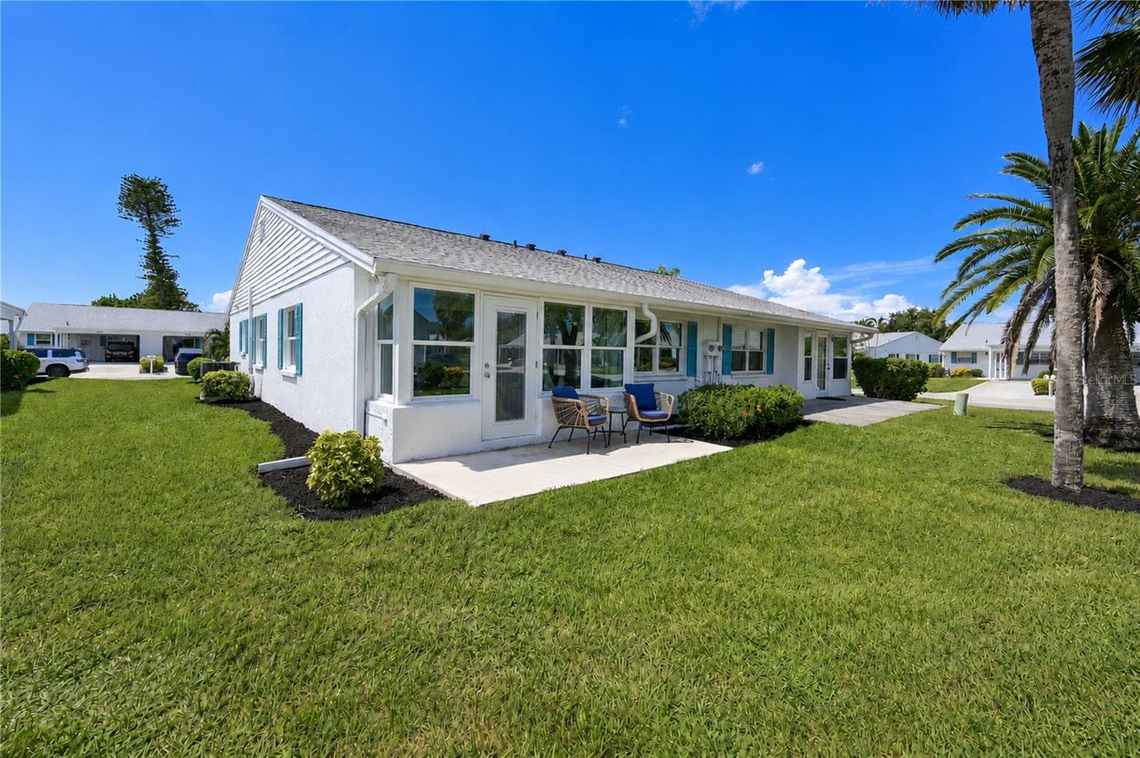 Back of villa with patio - 9411 CONCORD CIR, BRADENTON