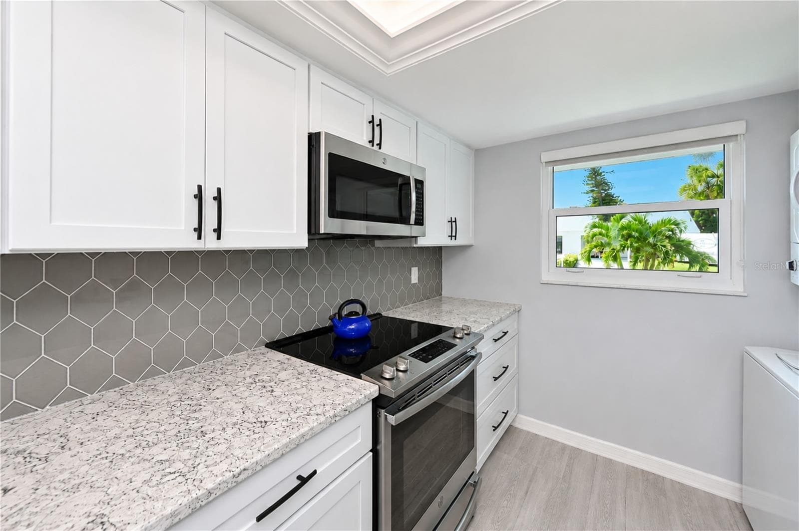 View of kitchen to front on angle - 9411 CONCORD CIR, BRADENTON