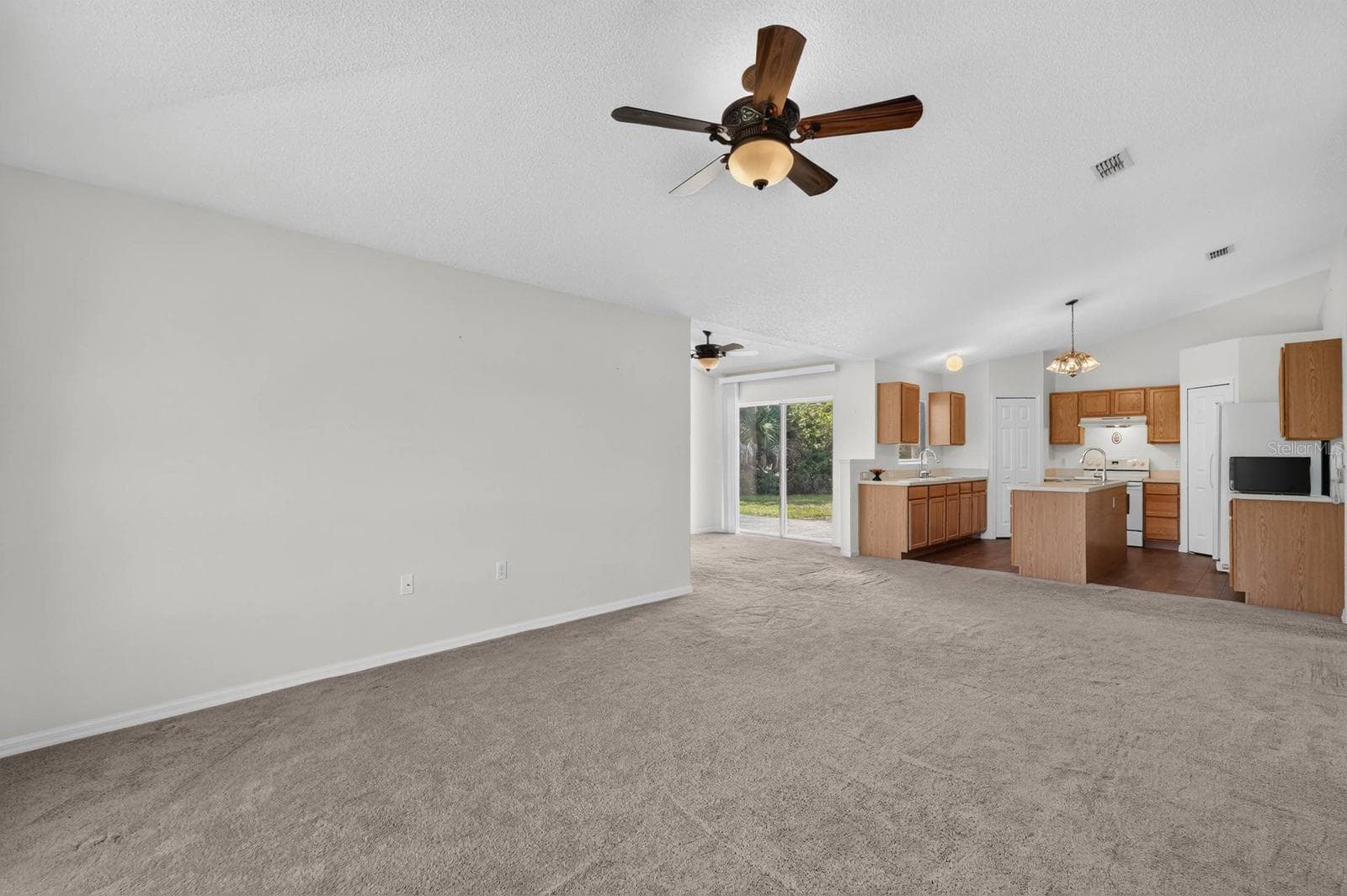 Family room looking towards the kitchen - 99 PICKERING DR, PALM COAST