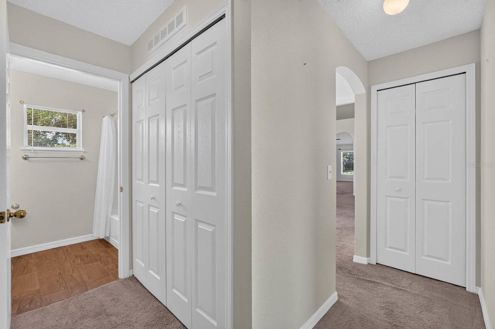 guest hallway with laundry closet and to the right down the hall the linen closet - 99 PICKERING DR, PALM COAST