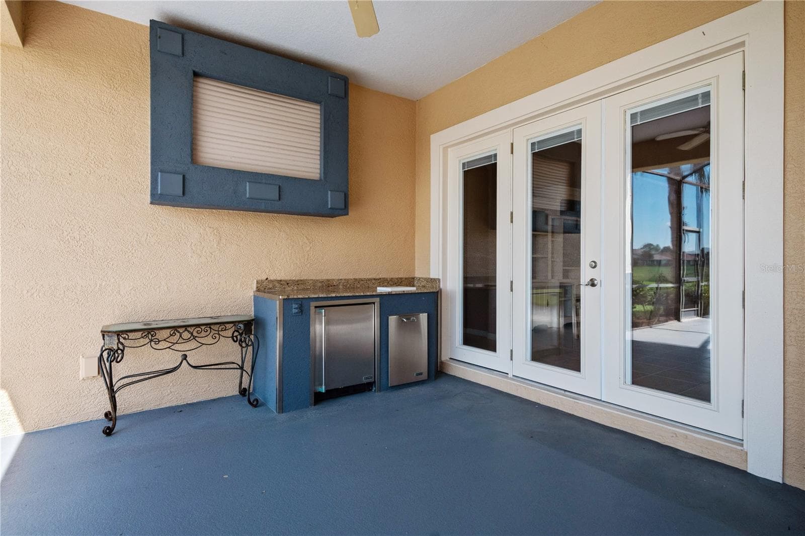 Step outside to the screen enclosed lanai and you'll find a bar area with refrigerator, and custom wall mounted TV cabinet. - 2464 LAUREL GLEN DR, LAKELAND
