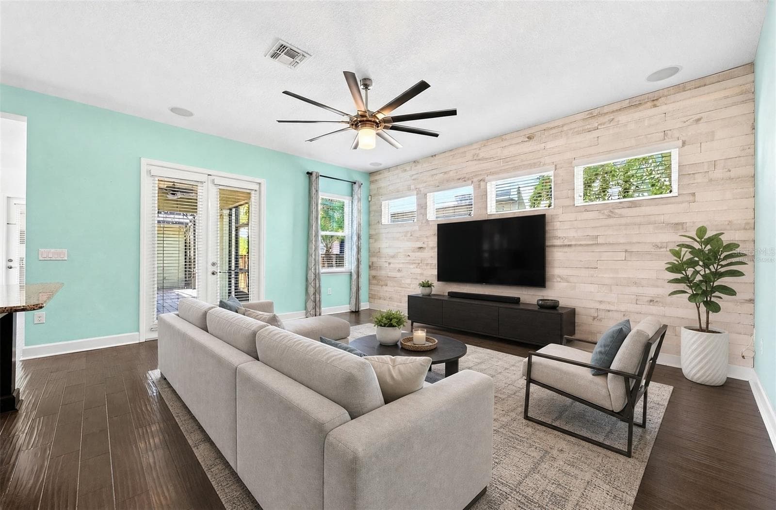 A custom accent wall adds personality to the living room. Virtually Staged. - 8130 LAUREATE BLVD, ORLANDO