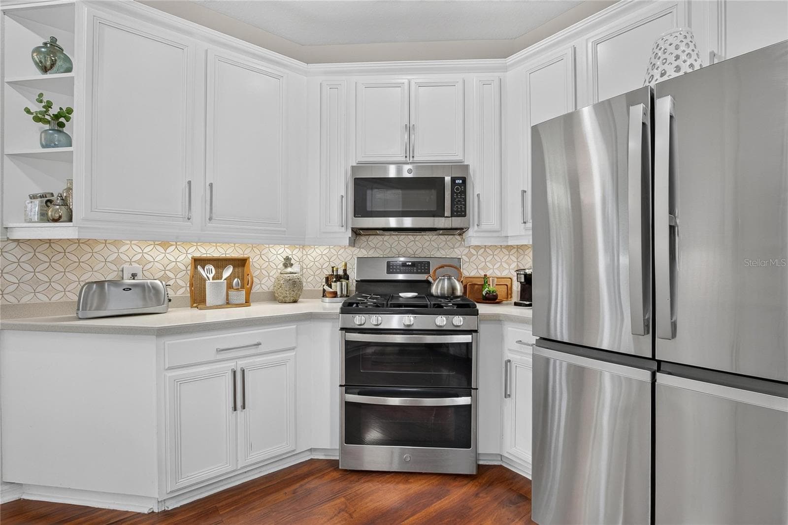Bright kitchen with breakfast bar, abundant cabinetry, generous counter space, gas range and newer stainless steel appliances. - 10807 SIERRA VISTA PL, TAMPA