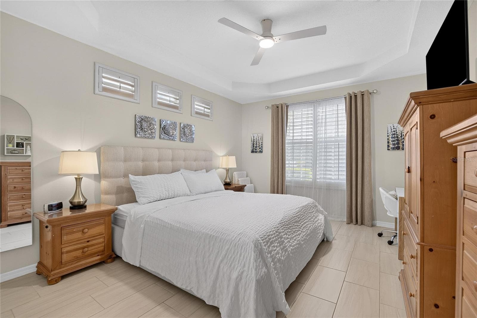Spacious first-floor primary suite with tray ceiling, plantation shutters and abundant natural light. - 10807 SIERRA VISTA PL, TAMPA