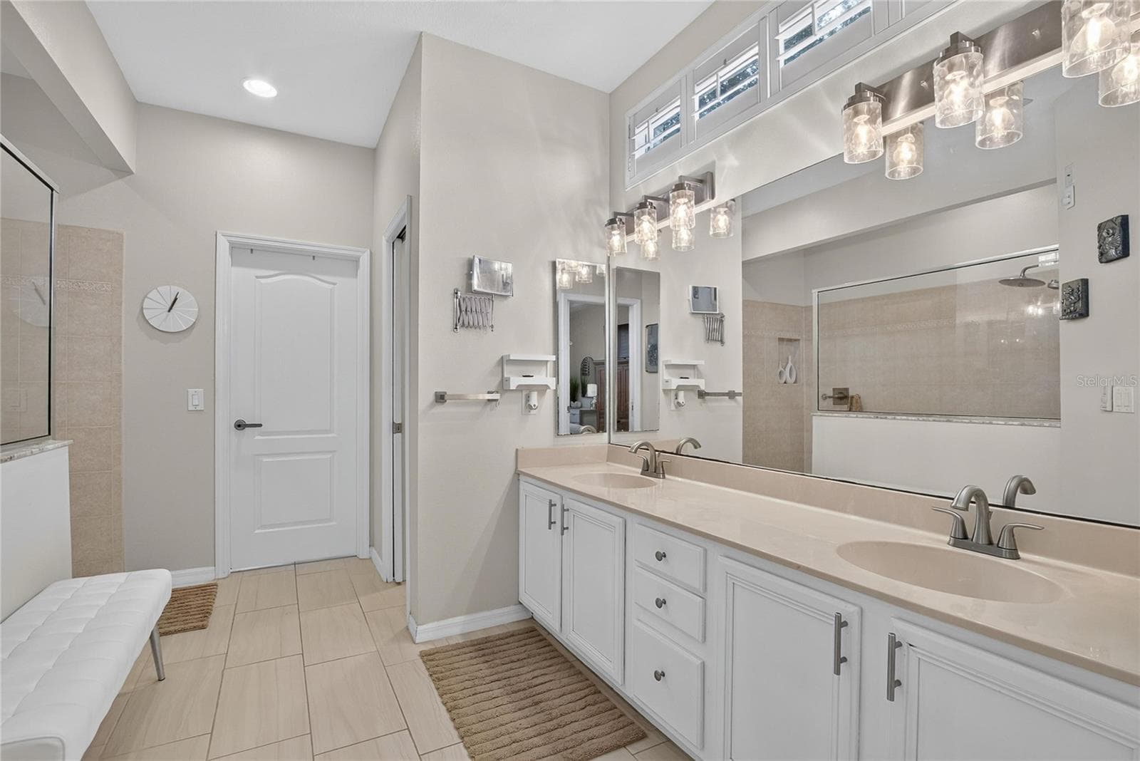 Spacious primary bath with dual-sink vanity and walk-in closet featuring additional under-stair storage - 10807 SIERRA VISTA PL, TAMPA