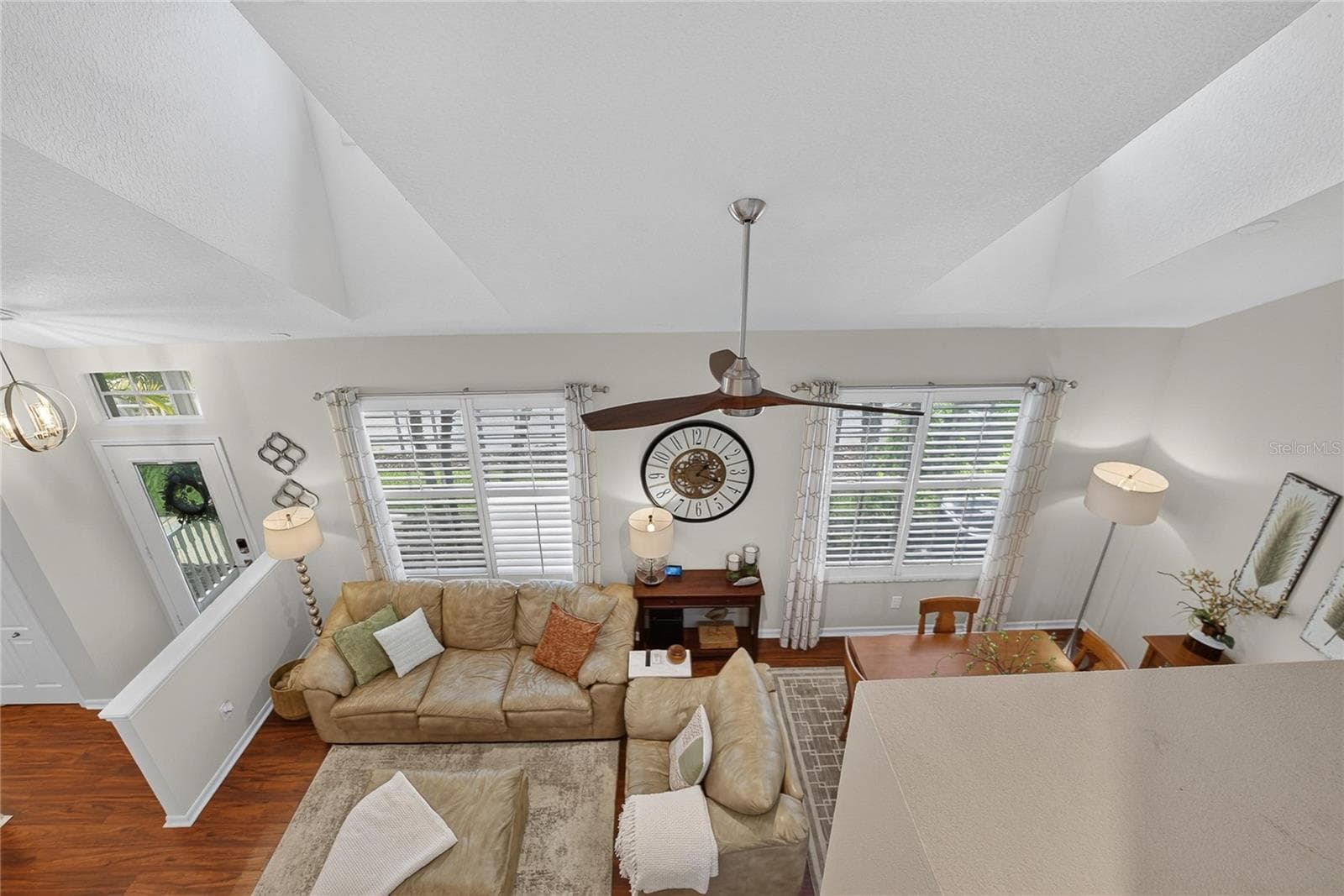 Loft overlooks the open living and dining areas below, highlighting the home’s soaring ceilings and open-concept design. - 10807 SIERRA VISTA PL, TAMPA