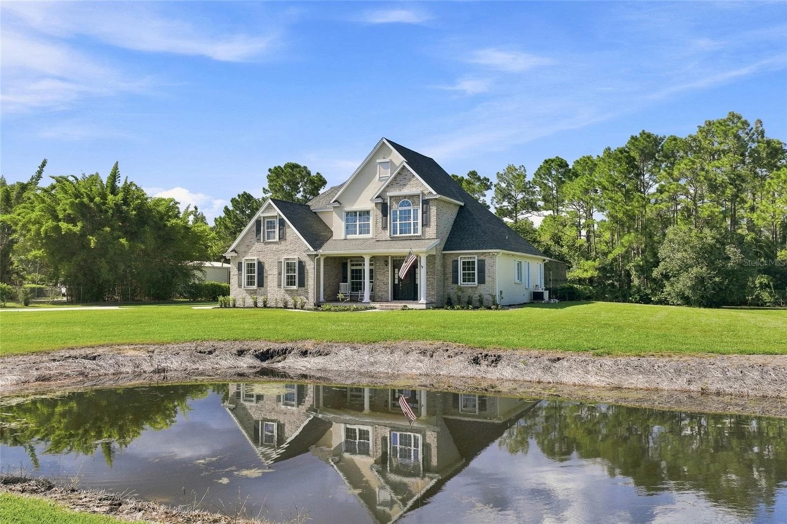 Front of home with pond view - 4441 DEER RUN RD, ST CLOUD