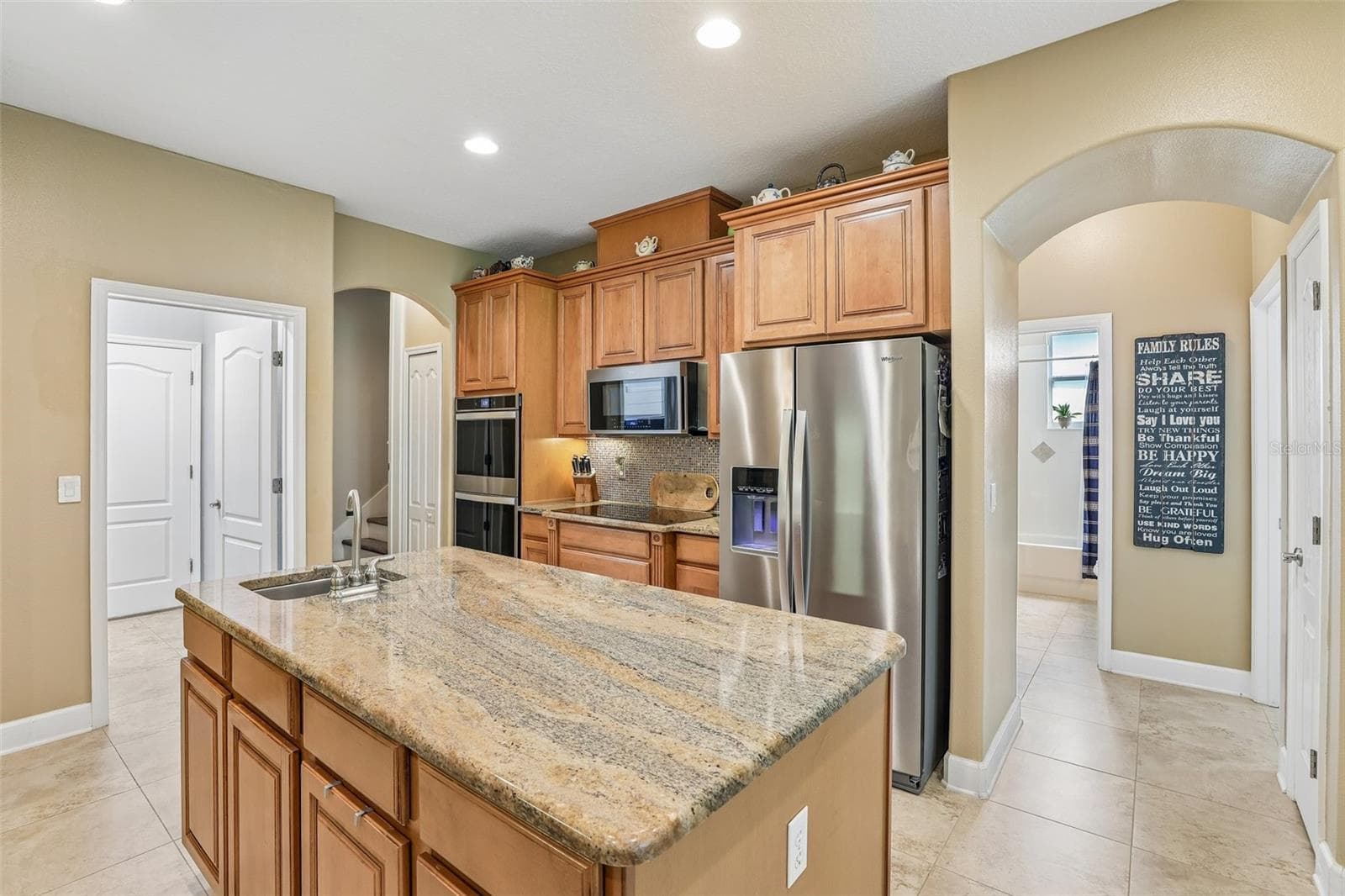 Large center island complete with a prep sink. - 2431 PONKAN SUMMIT DR, APOPKA