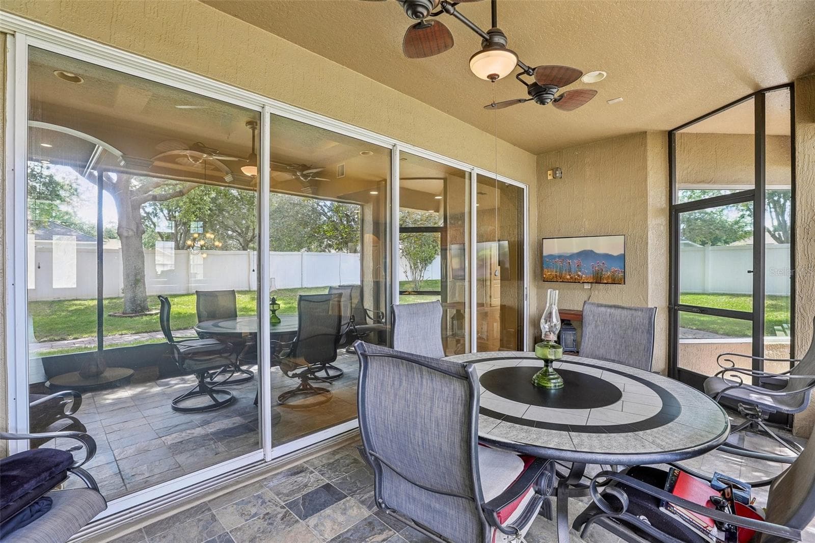 A wall of sliding glass doors open up to the screened lanai. - 2431 PONKAN SUMMIT DR, APOPKA